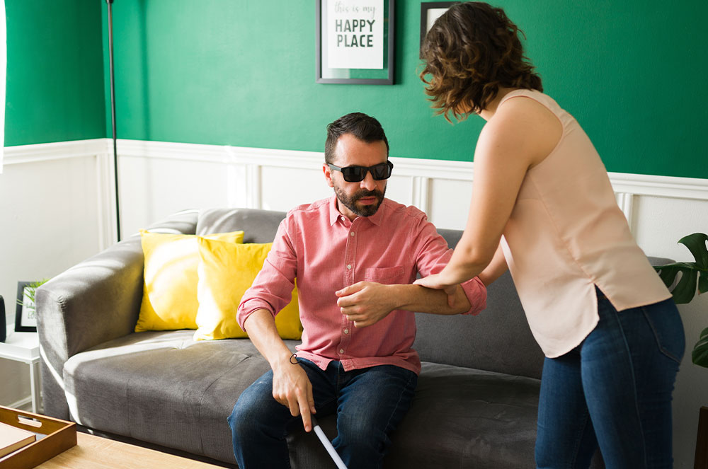 a blind man being asssted